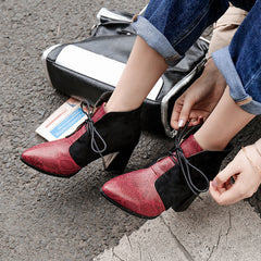 Pointy snakeskin lace-up boots